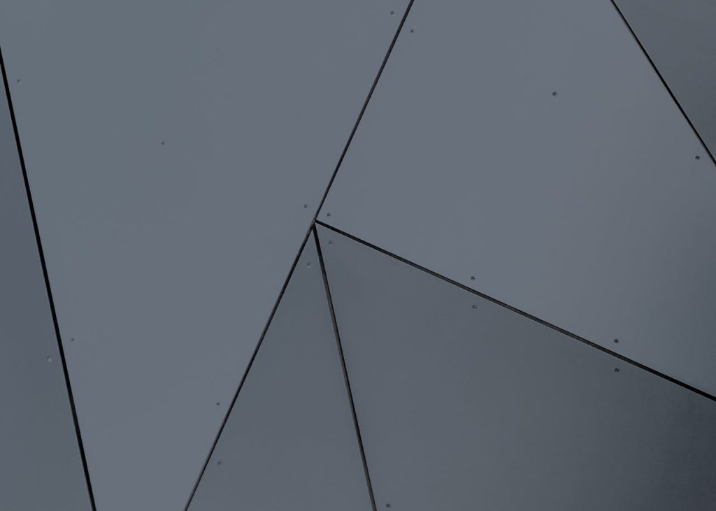 Abstract geometric facade with grey panels and sharp lines in London, Ontario.
