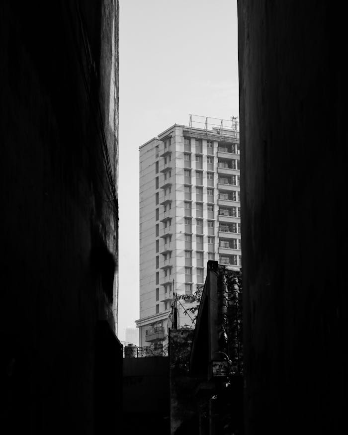 A tall building viewed through a narrow alleyway in Bandung, Indonesia.